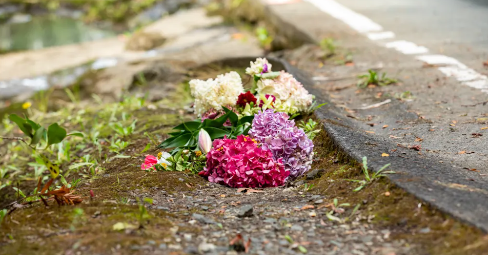 Flowers at the scene where the car was washed away. Photo: RNZ 