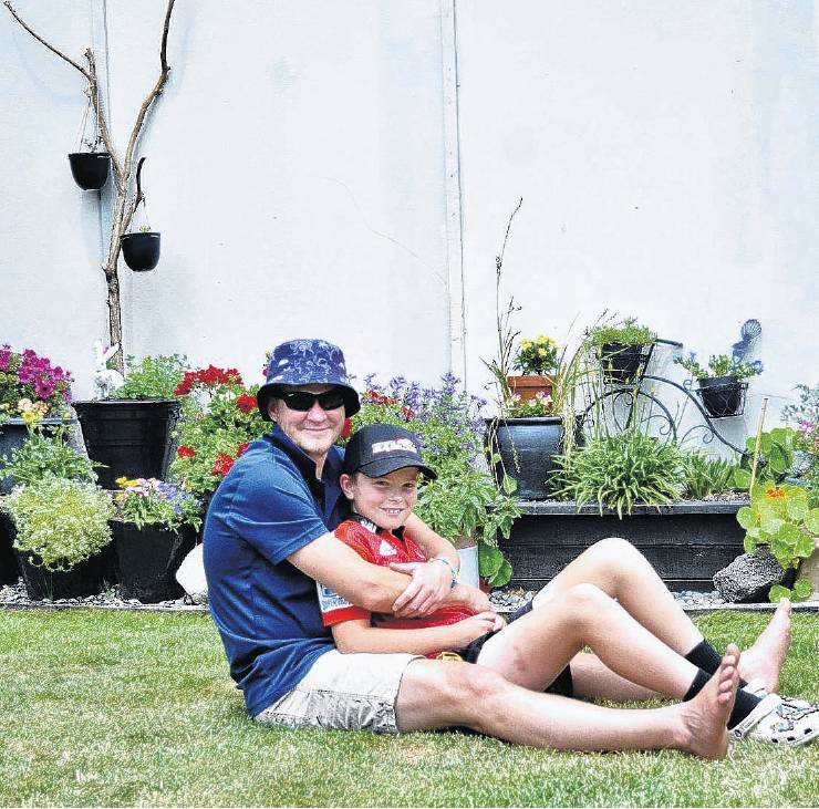 Cal Wallace with his son Flynn, 11, on the lawn in their garden, one of six in Rangiora that were...