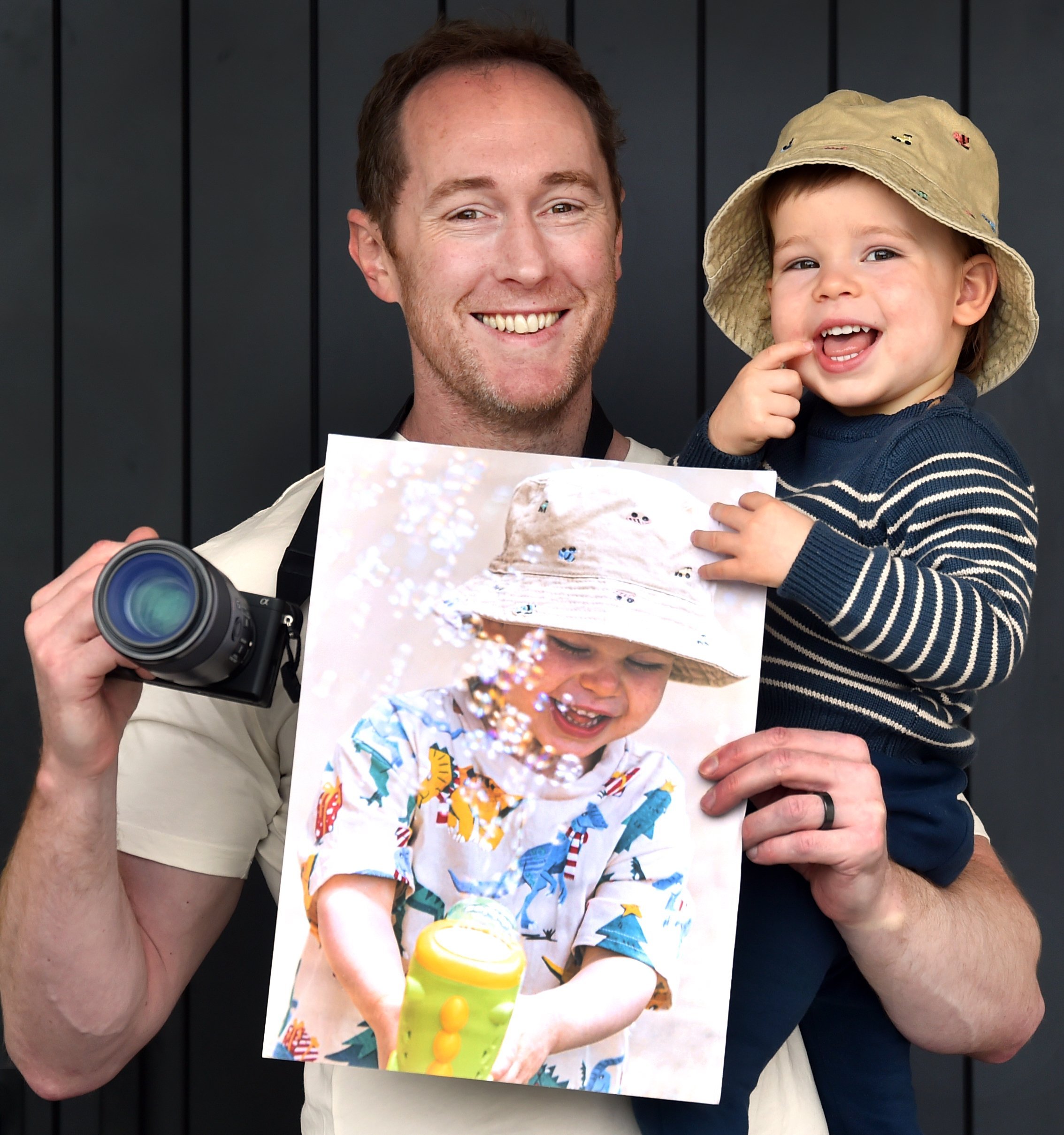 Fairfield resident Nevin Davie holds his winning photo and the real-life subject, his son Leon...