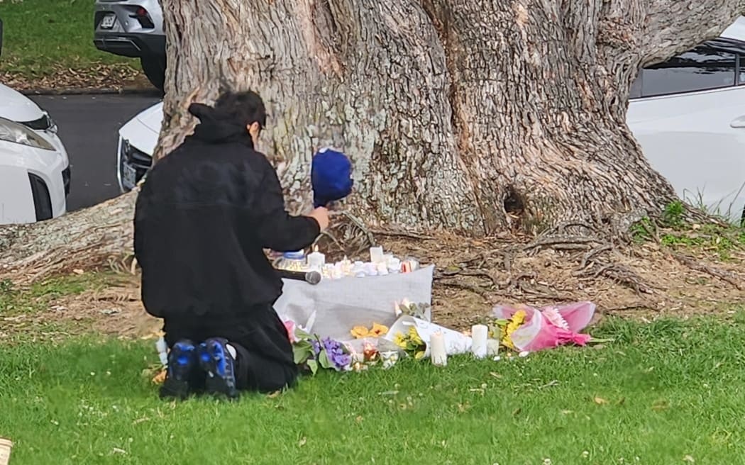 One of the mourners on Auckland's domain as many gathered to remember missing teen Sharon...