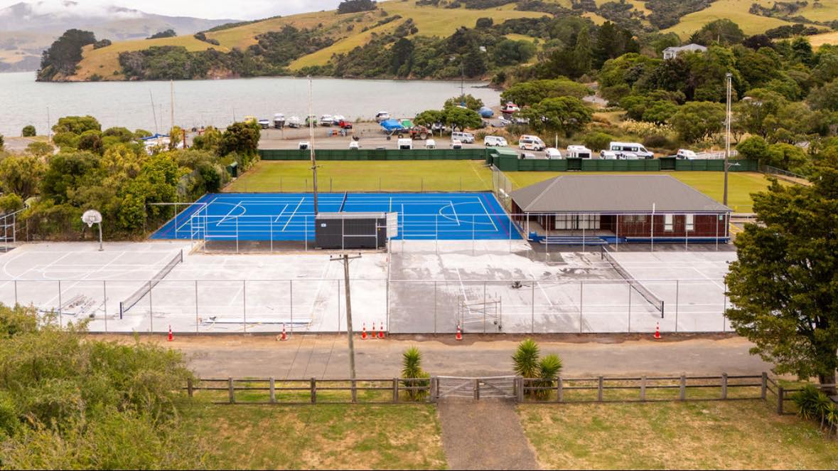 The upgraded court has been fitted with new blue astroturf, while the other two will be equipped...