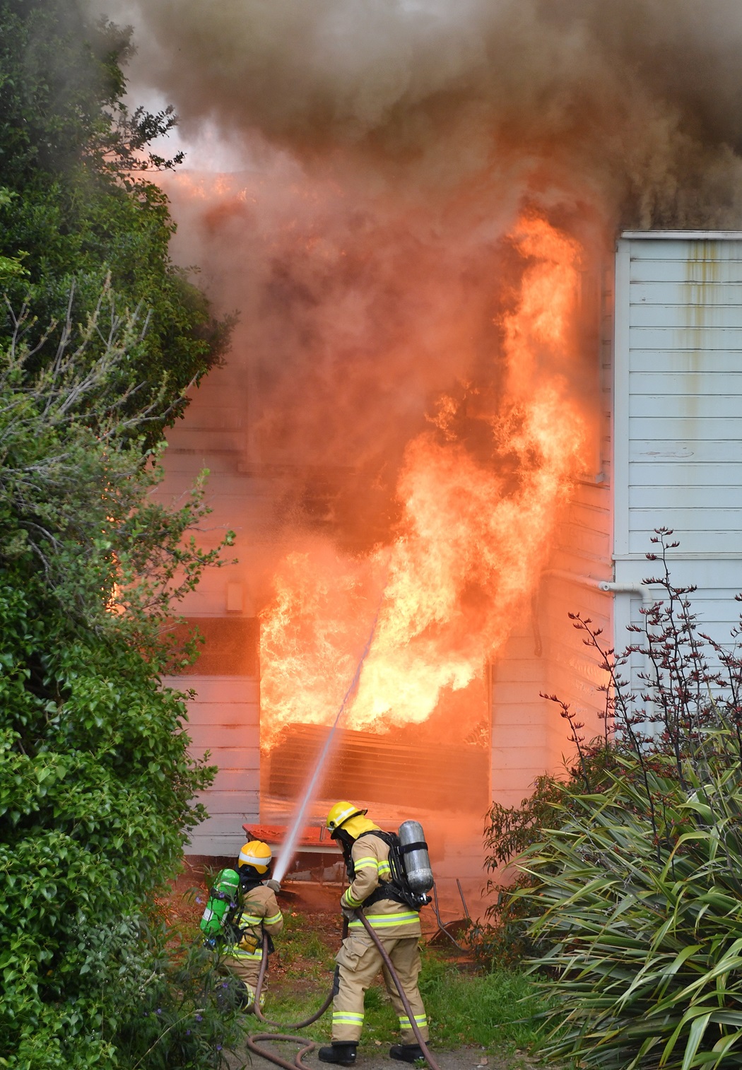 Firefighters battle a large fire at the Roslyn Scout Hall yesterday.