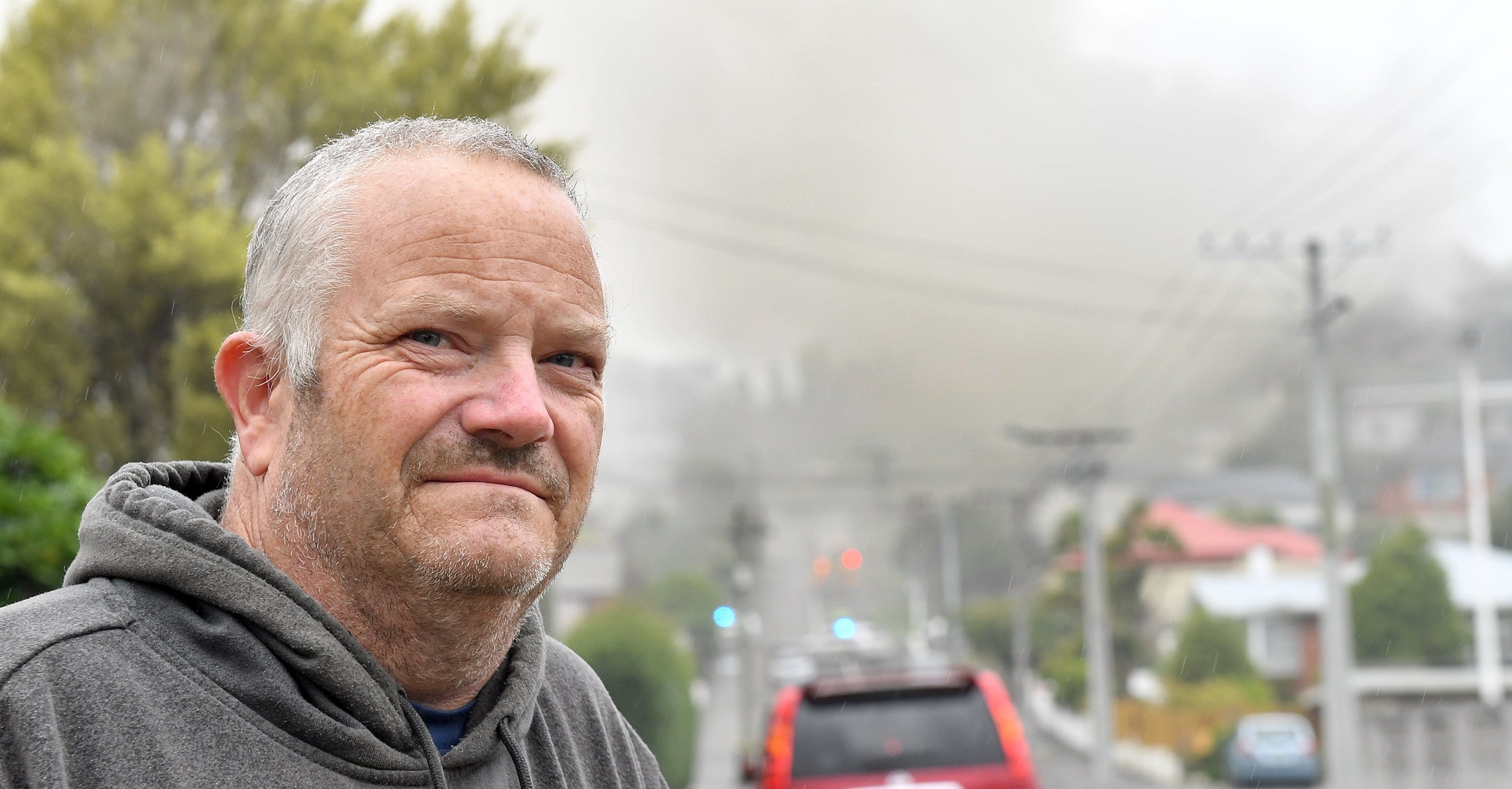 Veteran scout leader Shaun Adie, on School St ,with the Roslyn Scout Hall blowing pools of smoke...