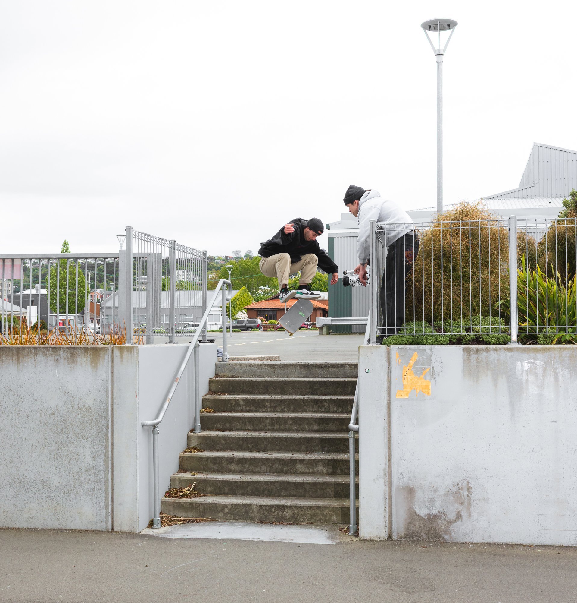 Chilton Phillips shoots JD Bennett as he does a kick-flip down stairs.