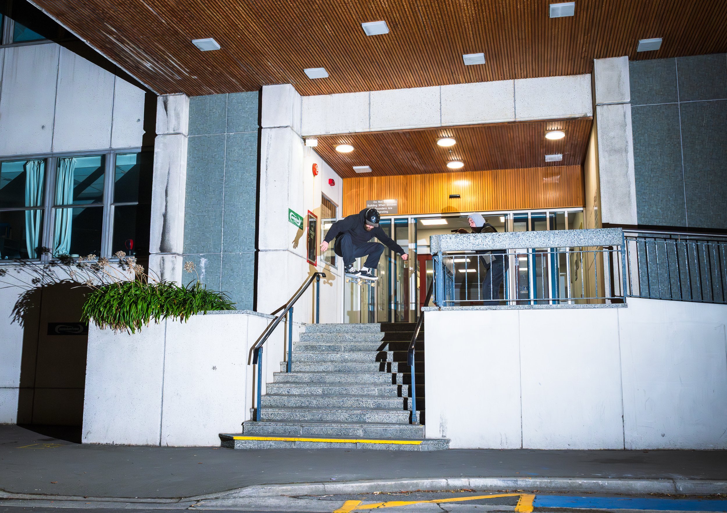 Chilton Phillips films Isherwood as he does an ollie over stairs.