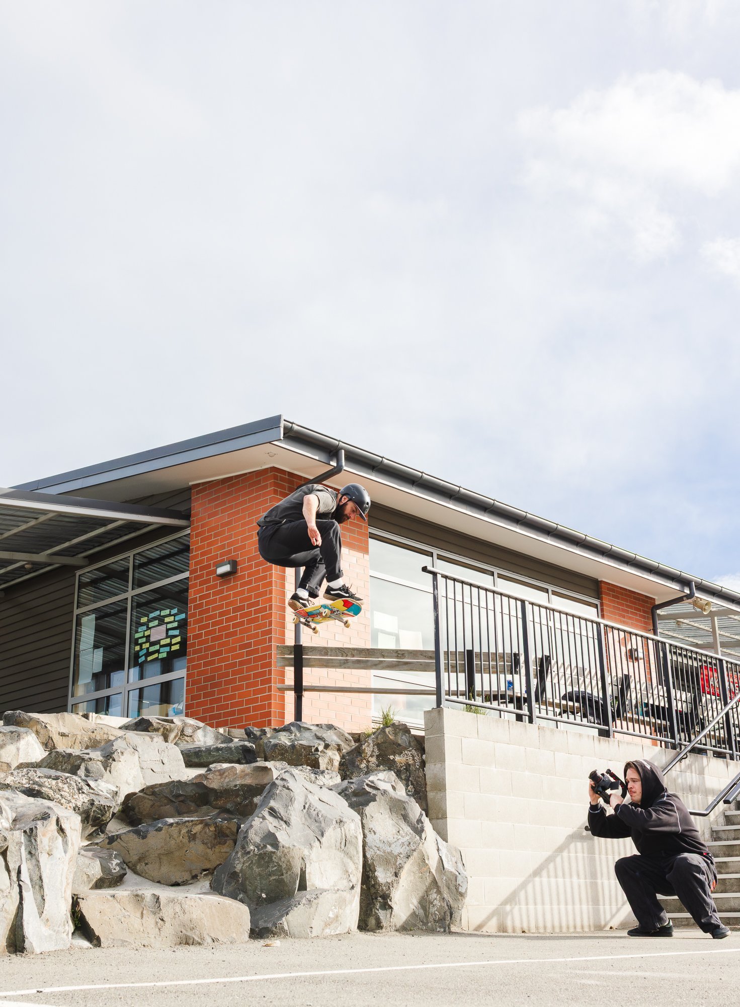 Elliot Chilton Phillips shoots Tyler Isherwood as he does an ollie over rocks. PHOTOS: ZACH SULLIVAN