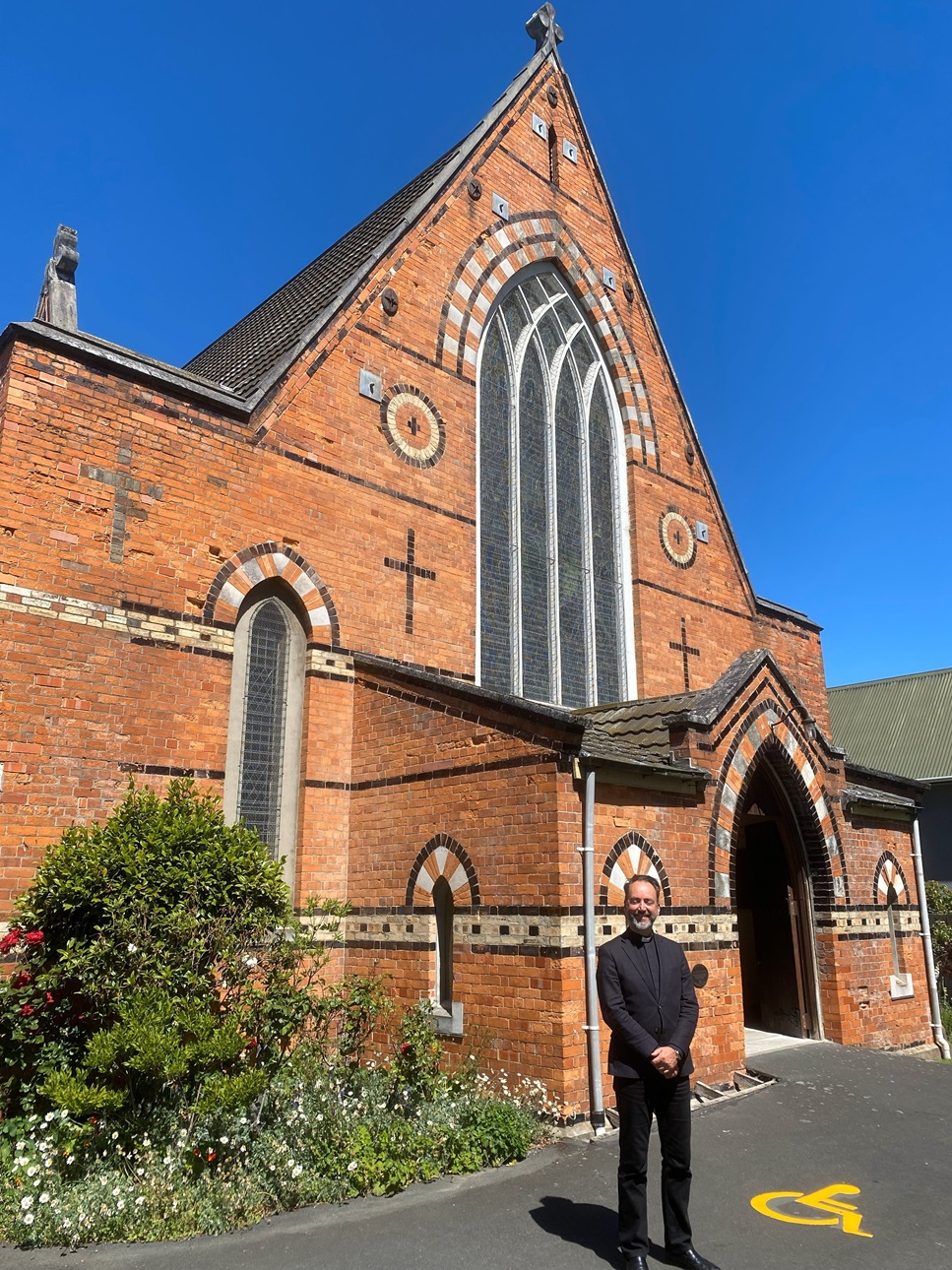 All Saints’ Church vicar Canon Dr Michael Wallace is pictured with the historic church, which...