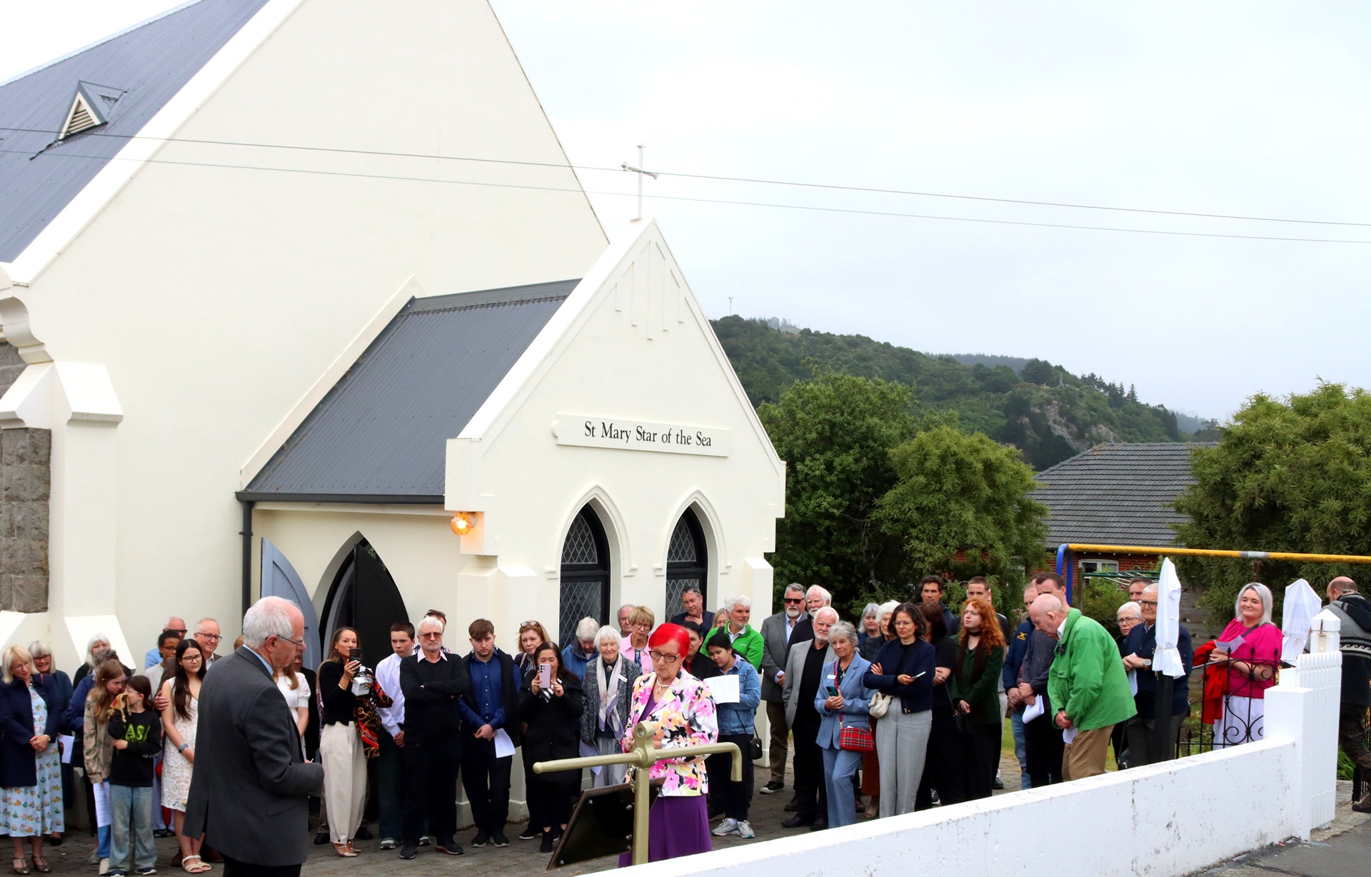 Guests gather outside St Mary Star of the Sea church in Port Chalmers for the unveiling of...