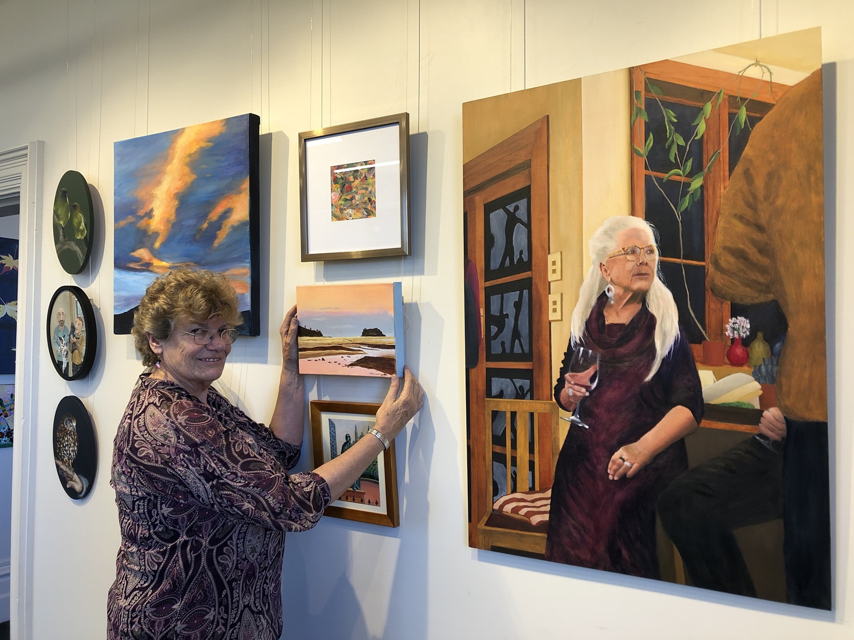 Otago Art Society Summer Exhibition convener Jenny Longstaff sets up the exhibition ahead of its...