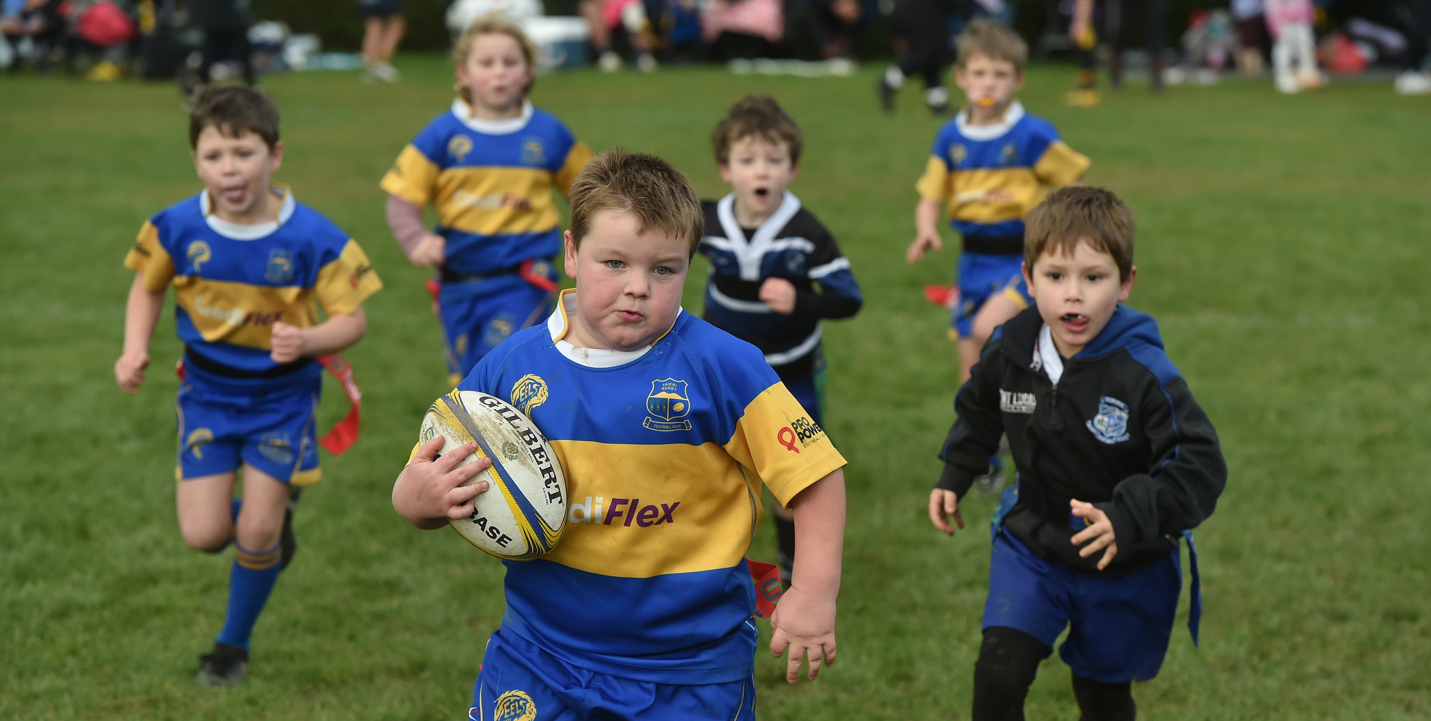 Determined Taieri Gold player Ollie Batt, 6, sprints towards the tryline to score against...