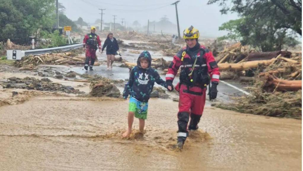 The Glover family evacuates during flooding in Te Araroa on the East Coast of the North Island...