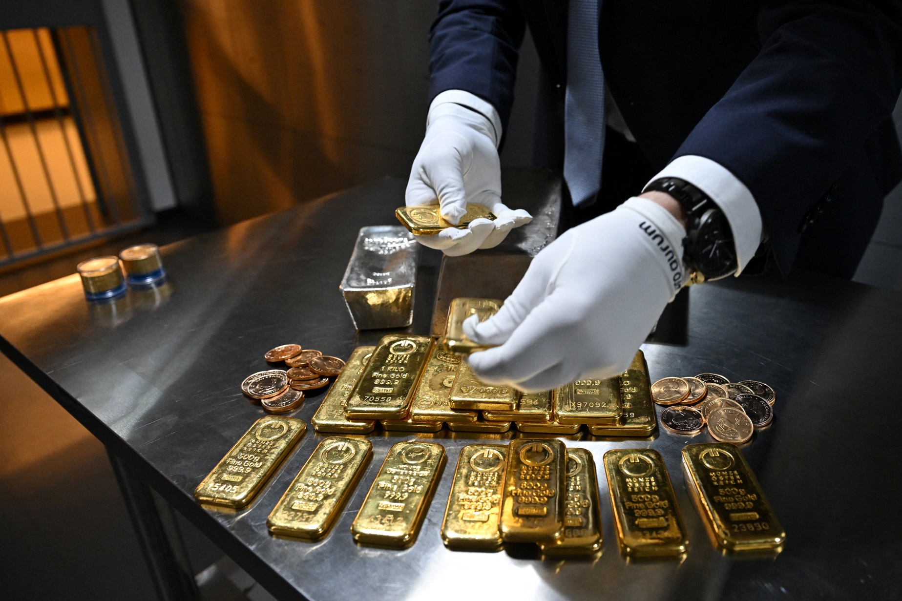 An employee shows gold bars of various values in a safe deposit room in Germany. Photo: Reuters