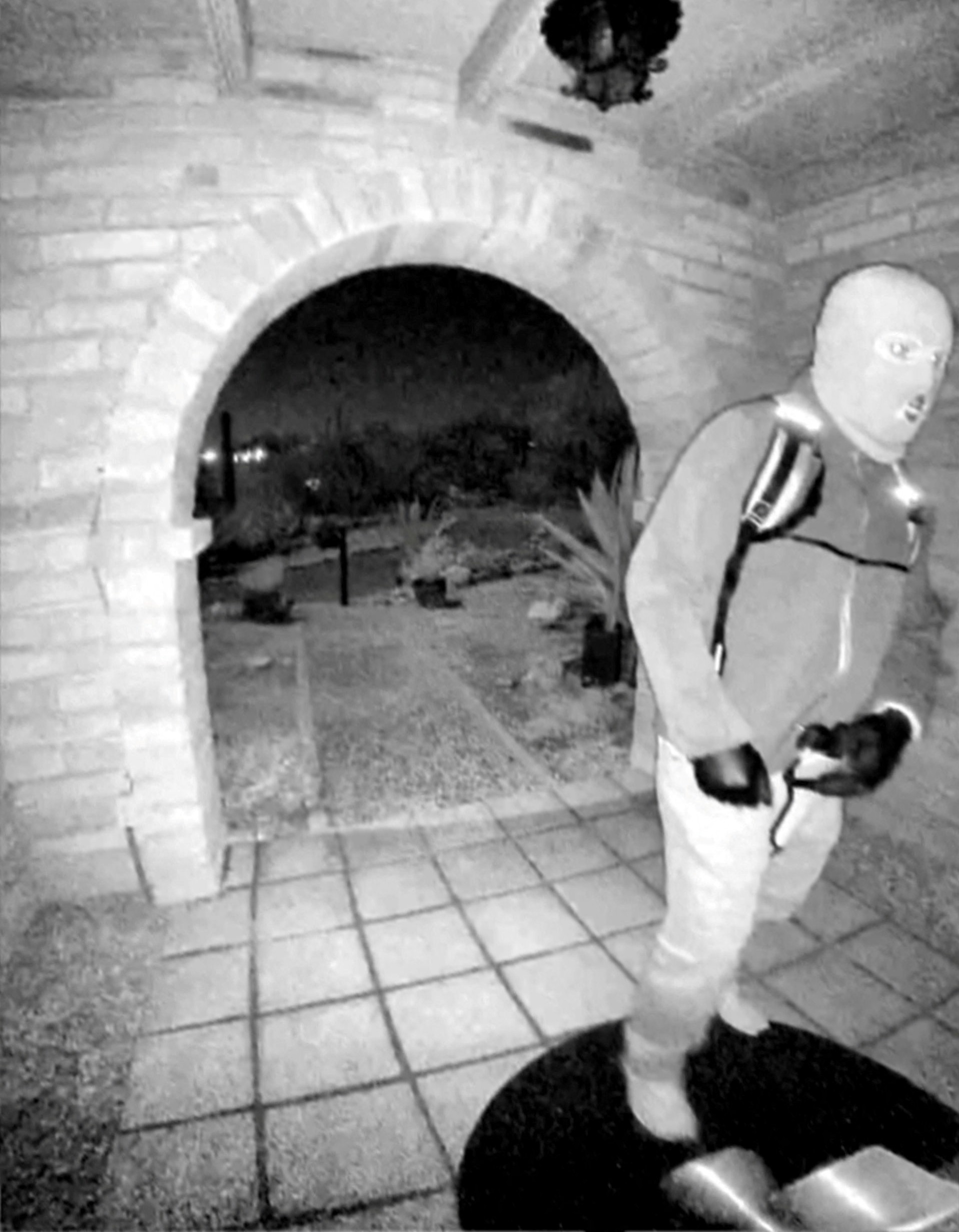 This image shows an armed person appearing to have tampered with the camera at Nancy Guthrie’s...