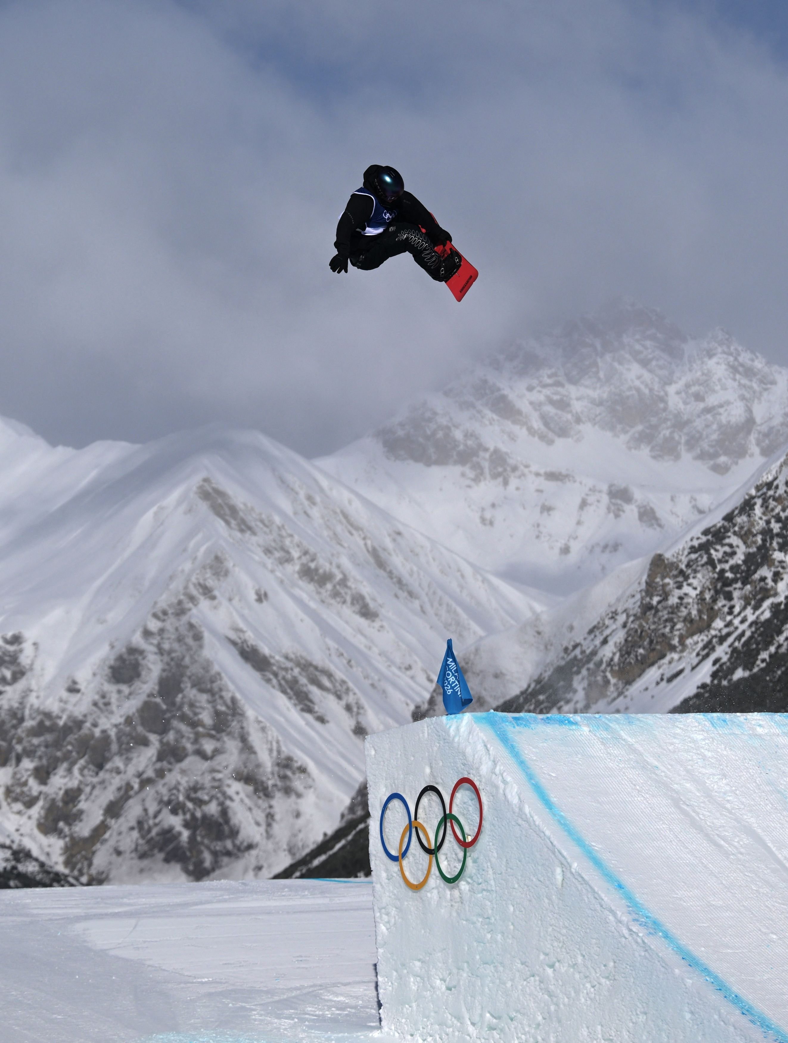 Dane Menzies, of New Zealand, in action during the Milano Cortina Olympics men’s snowboard...