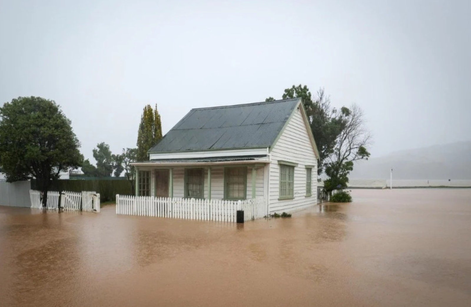A cottage in Akaroa surrounded by floodwaters this week. Photo: RNZ