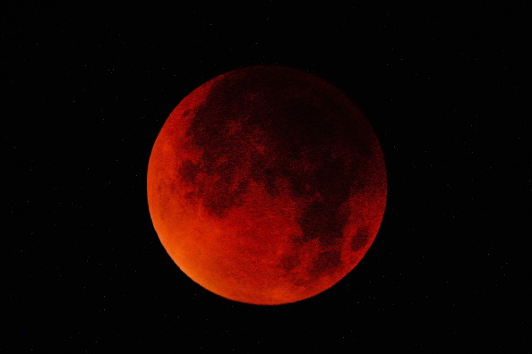 A total lunar eclipse cast a "blood moon" over the night sky, captured in Beijing, China, in...