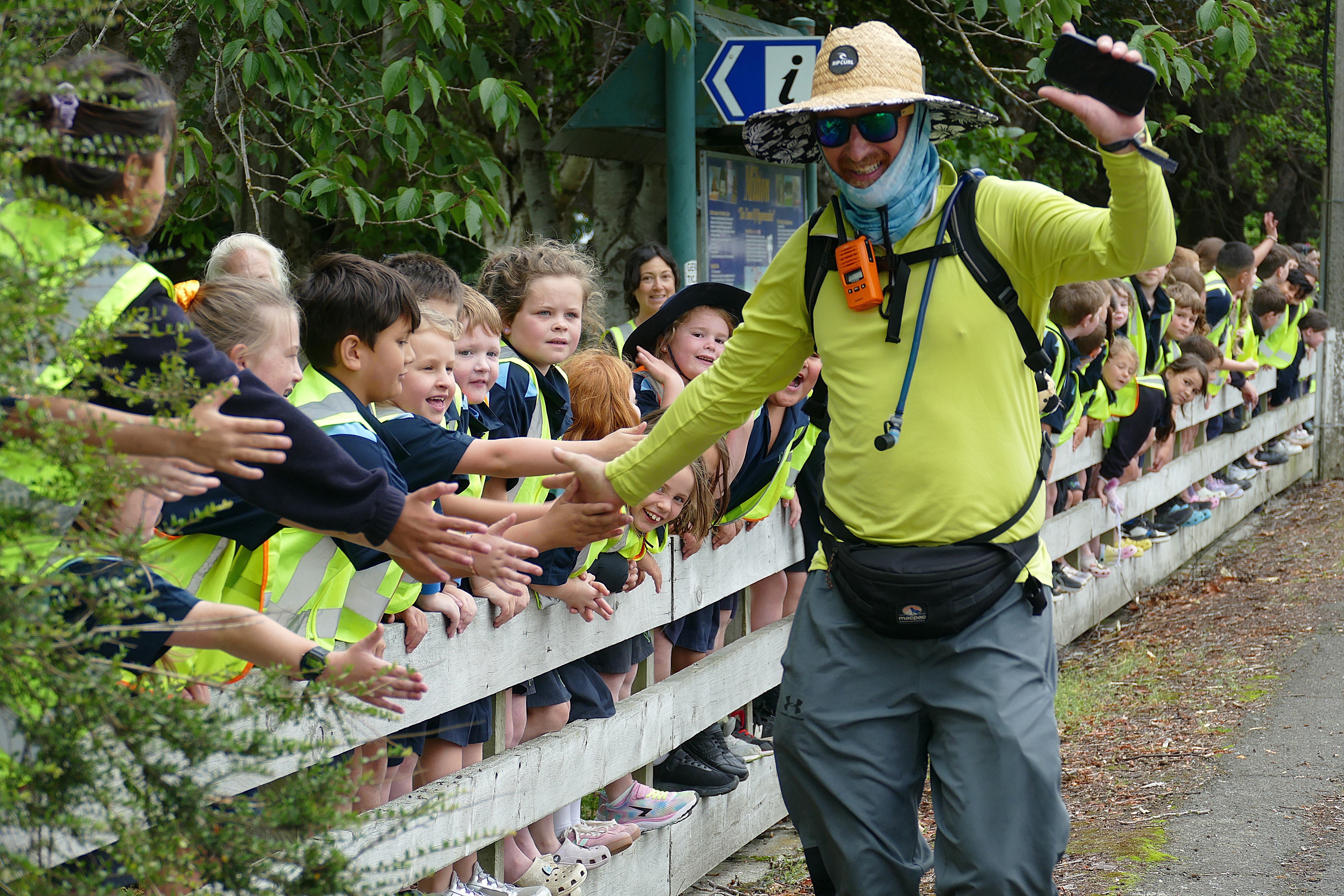 Hometown hero Shane Bichan high-fives pupils from Milton Primary School as he passes the town’s...