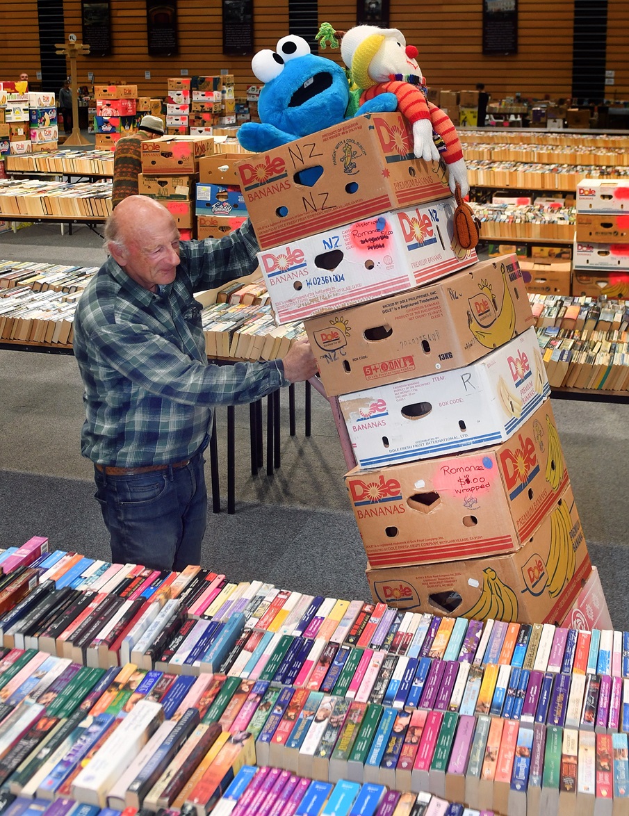 Regent Theatre Book Sale volunteer Oliver Harman lends a hand getting thousands of books sorted...