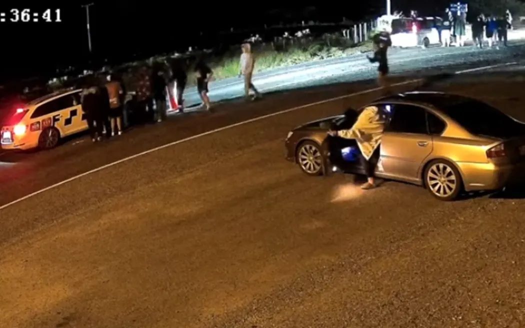 A video posted on YouTube showed about a dozen people approaching the police car. Photo: YouTube