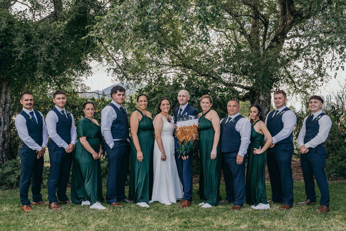 The bridal couple (centre) were supported by a large bridal party of family and friends. Photos:...