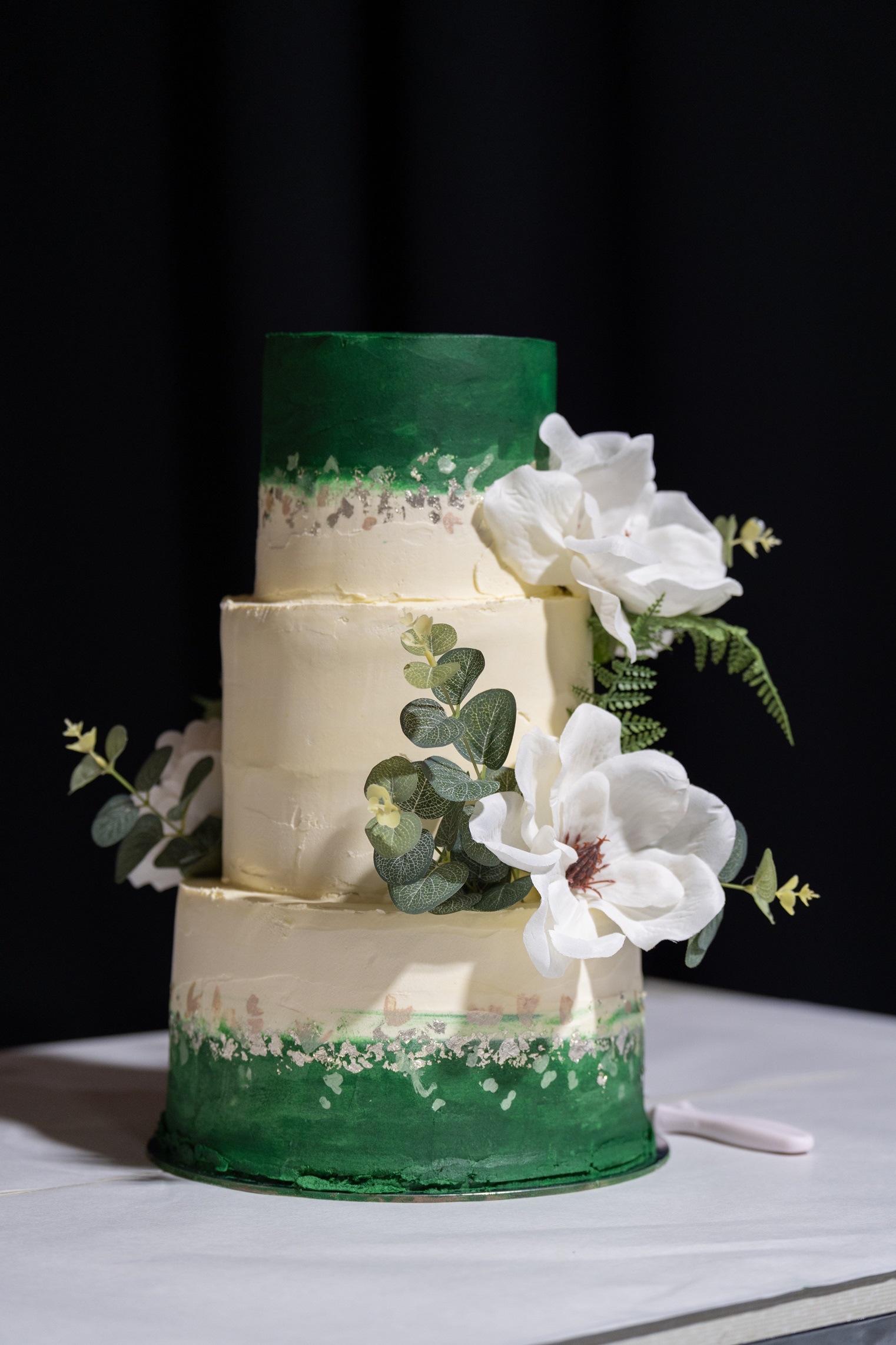 The three-tier chocolate wedding cake.

