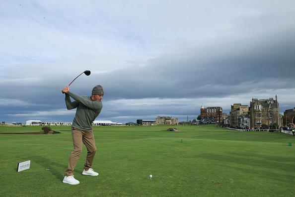 World surfing champion Kelly Slater tees off on the 18th hole at St Andrews during the Alfred...