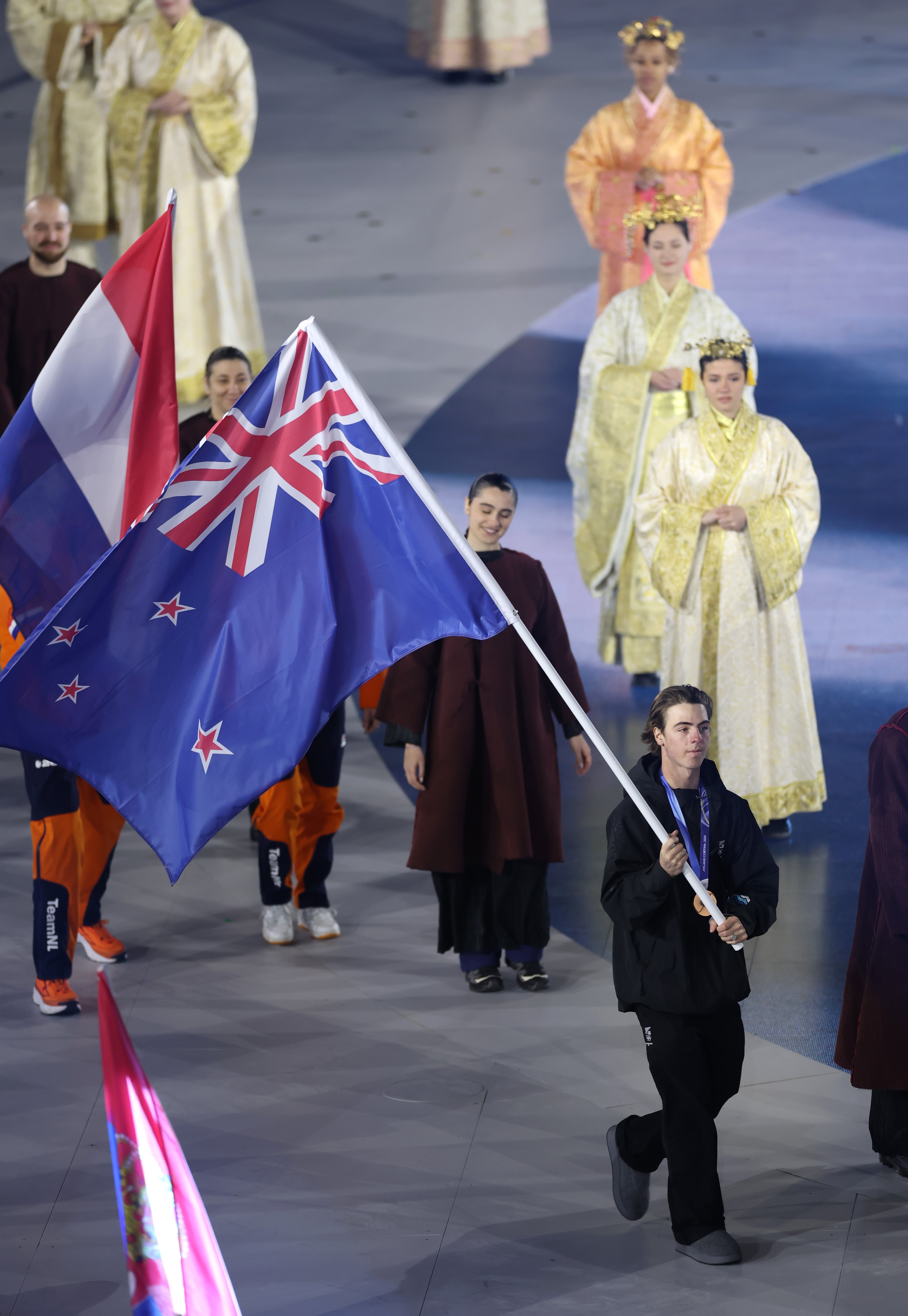 Luca Harrington, of Wānaka, carries the flag at the Winter Olympics closing ceremony, in Verona,...
