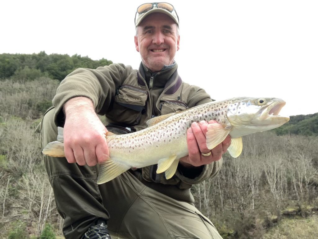 Allied Media cartoonist Shaun Yeo with his brown trout catch of the day, caught at Nokomai on the...
