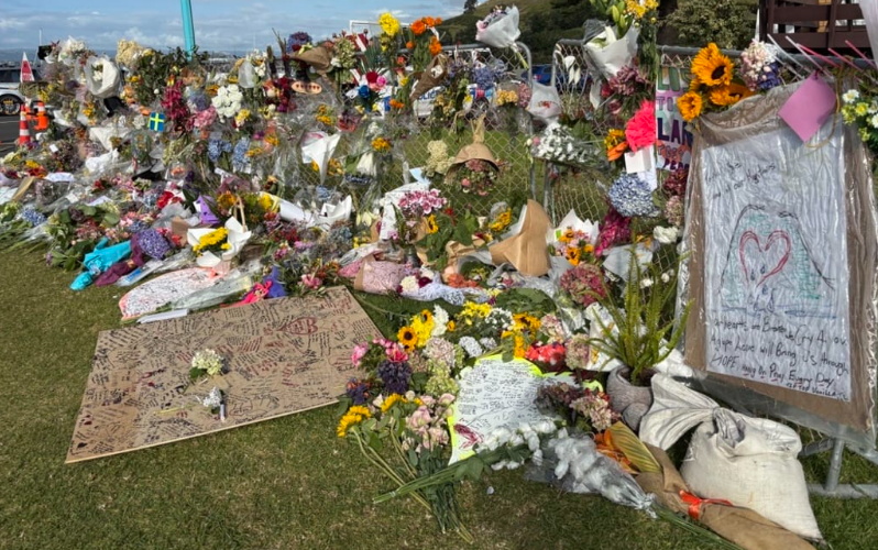 The cordon in Mount Maunganui following the deadly landslide is covered in tributes for the...