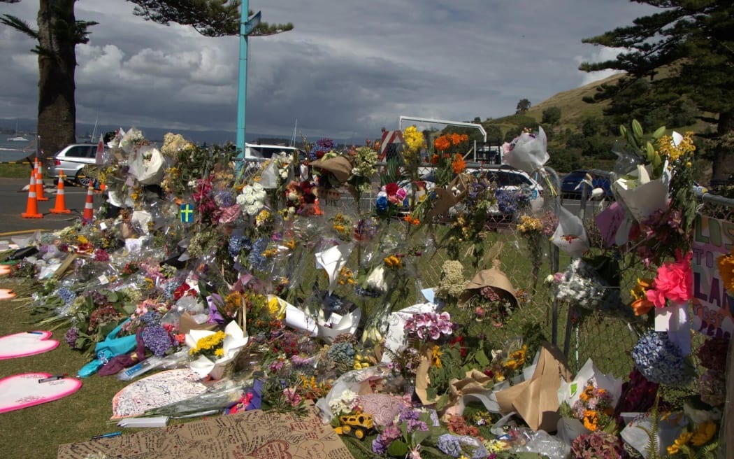 Bouquets and tributes at the Mount Maunganui landslide cordon. Photo: Ayla Yeoman via RNZ