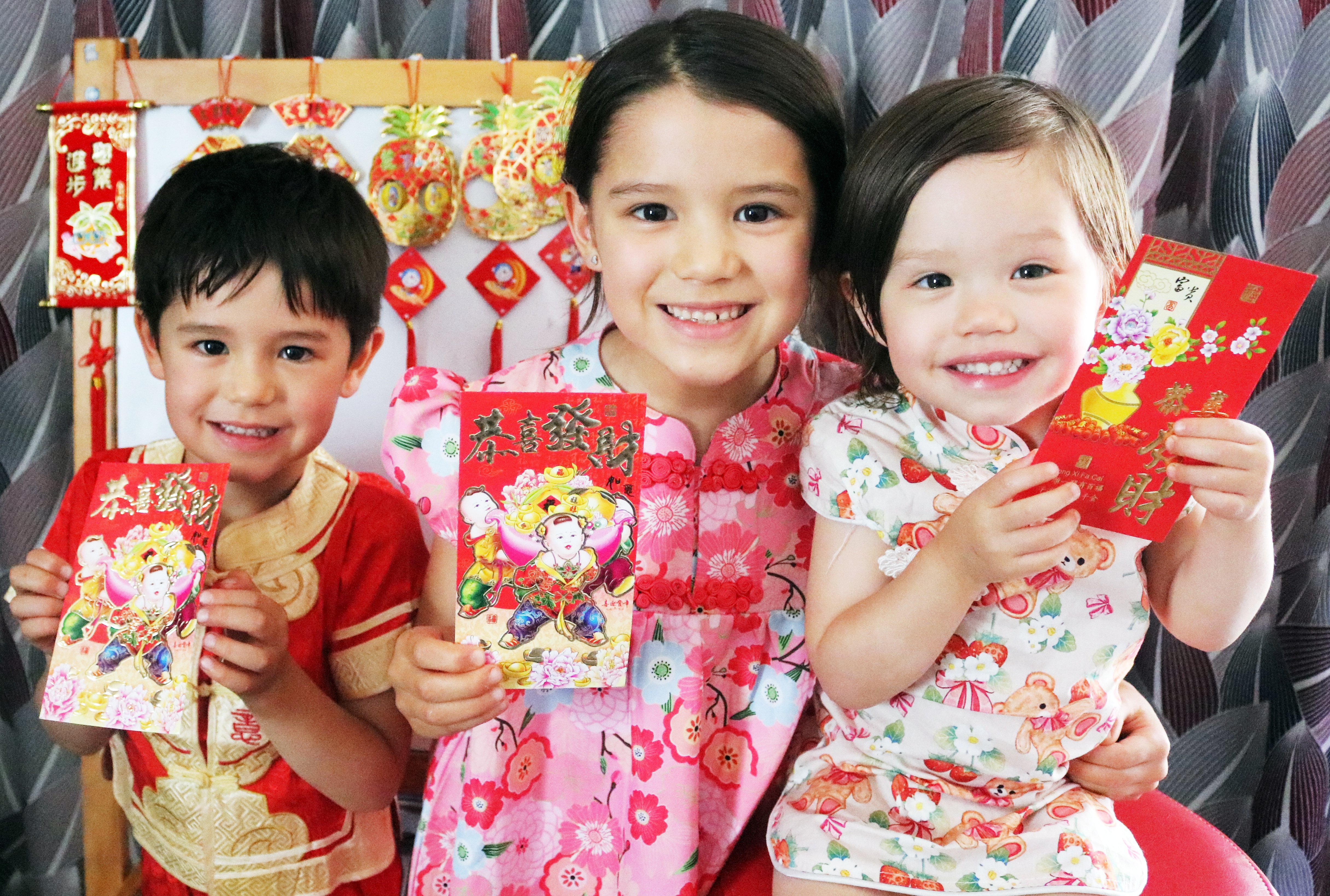 Excited to receive their ang pow (red envelopes) for Chinese New Year are (from left) Oliver, 5,...