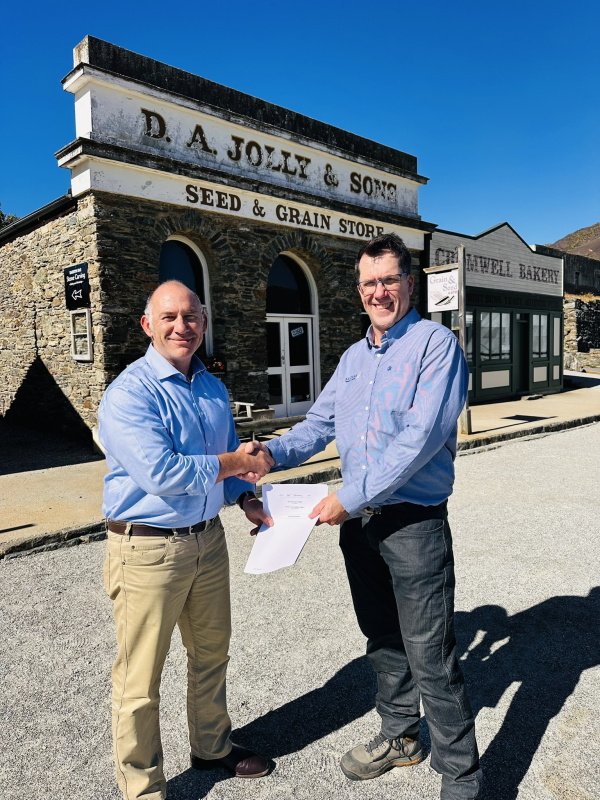 CODC chief executive Peter Kelly (left) shakes hands with Santana Minerals chief executive Damian...