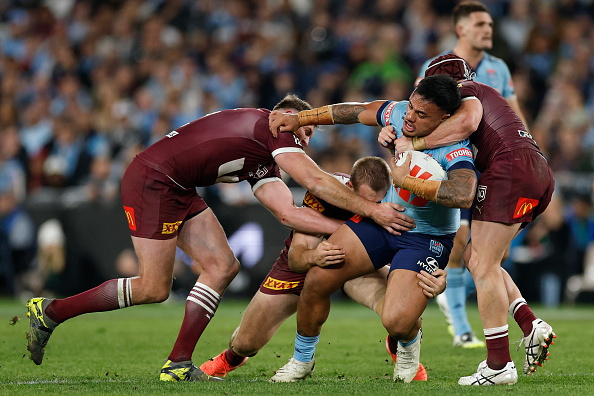 Spencer Leniu is tackled while carrying the ball for the Blues during last year's State of Origin...