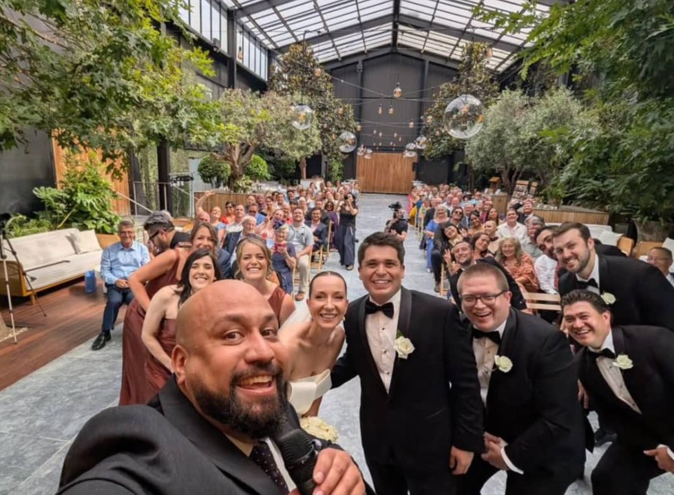 Auckland celebrant Nate Dunn with a couple getting married. Photo credit: Supplied