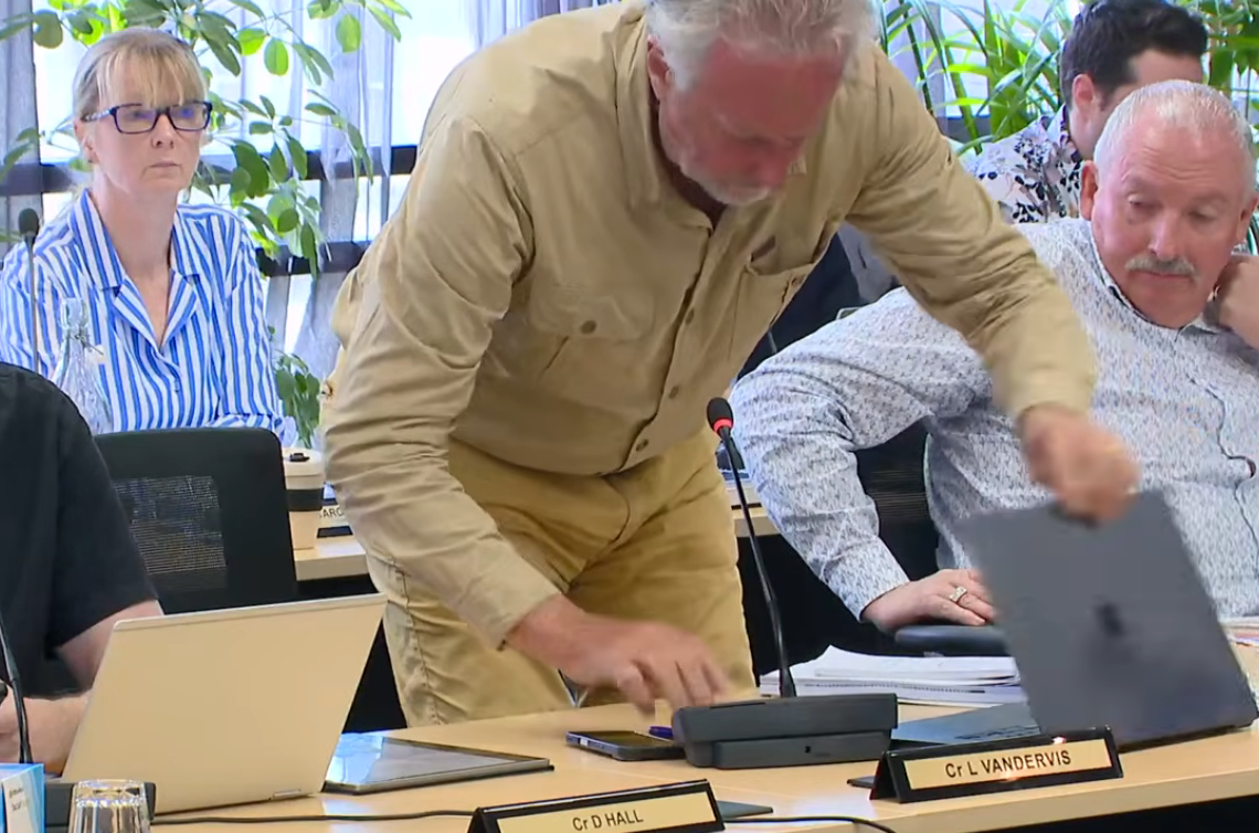 Cr Lee Vandervis packs up his things before leaving. Looking on is Cr Brent Weatherall IMAGE:...