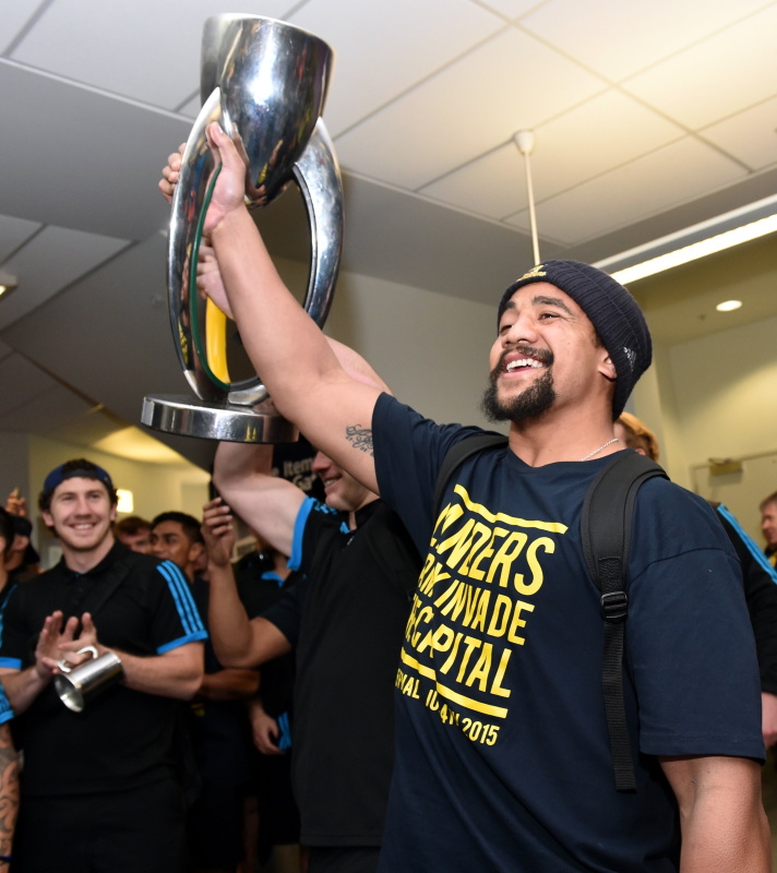Nasi Manu shows off the Super Rugby trophy after the Highlanders land at Dunedin Airport in 2015....