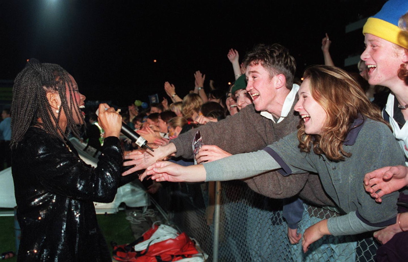 Fans reach out to the Boney M singer during the famous concert before the Highlanders-Crusaders...