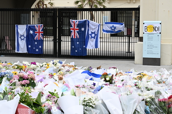 Hundreds of flowers lay on the ground at the memorial next to Bondi Pavilion at Bondi Beach in...