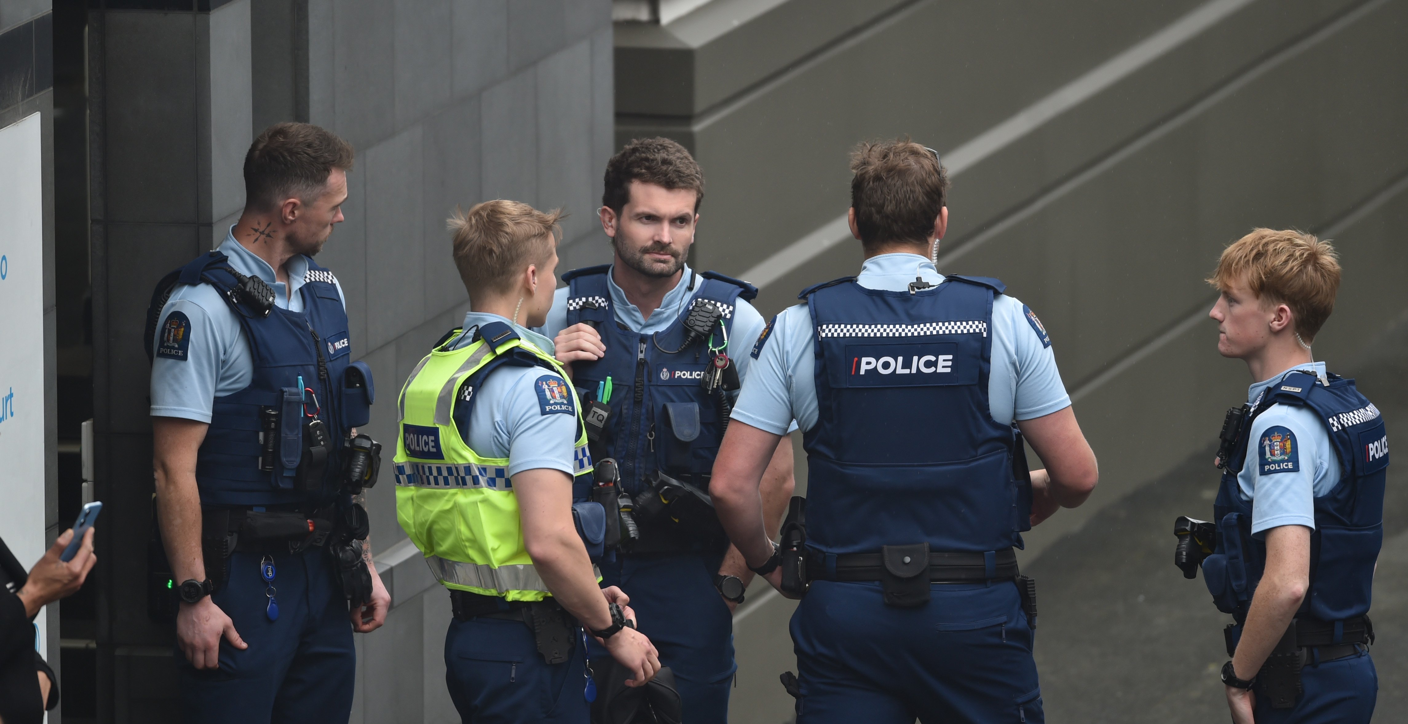 Police stand outside the Dunedin Courthouse after a defendant allegedly physically lashed out at...