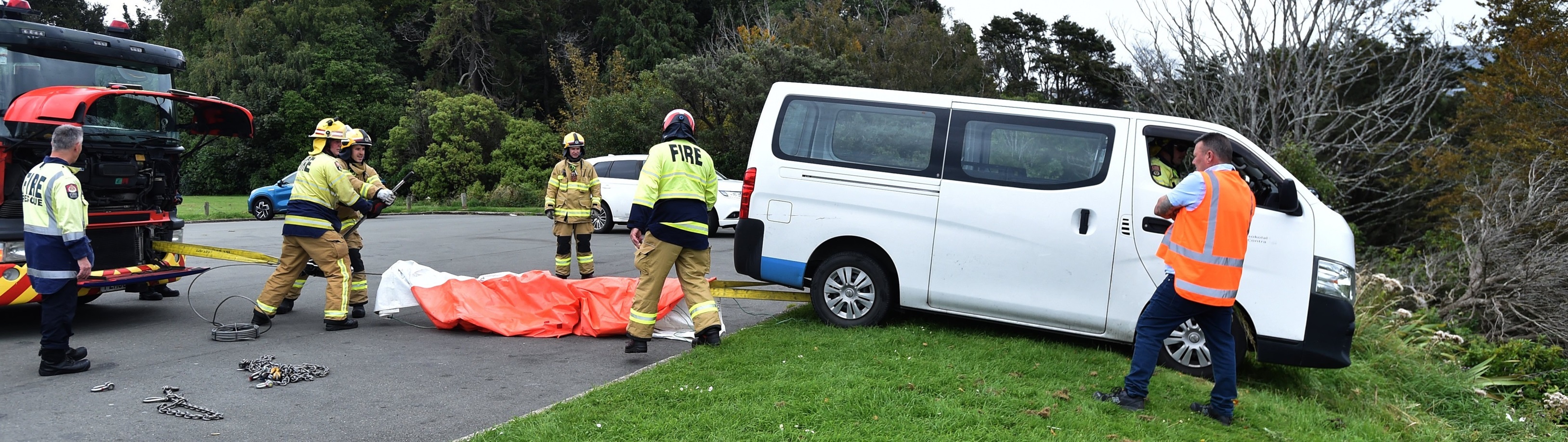 Emergency services use a winch to hoist a van up from over the edge of a steep bank near Unity...