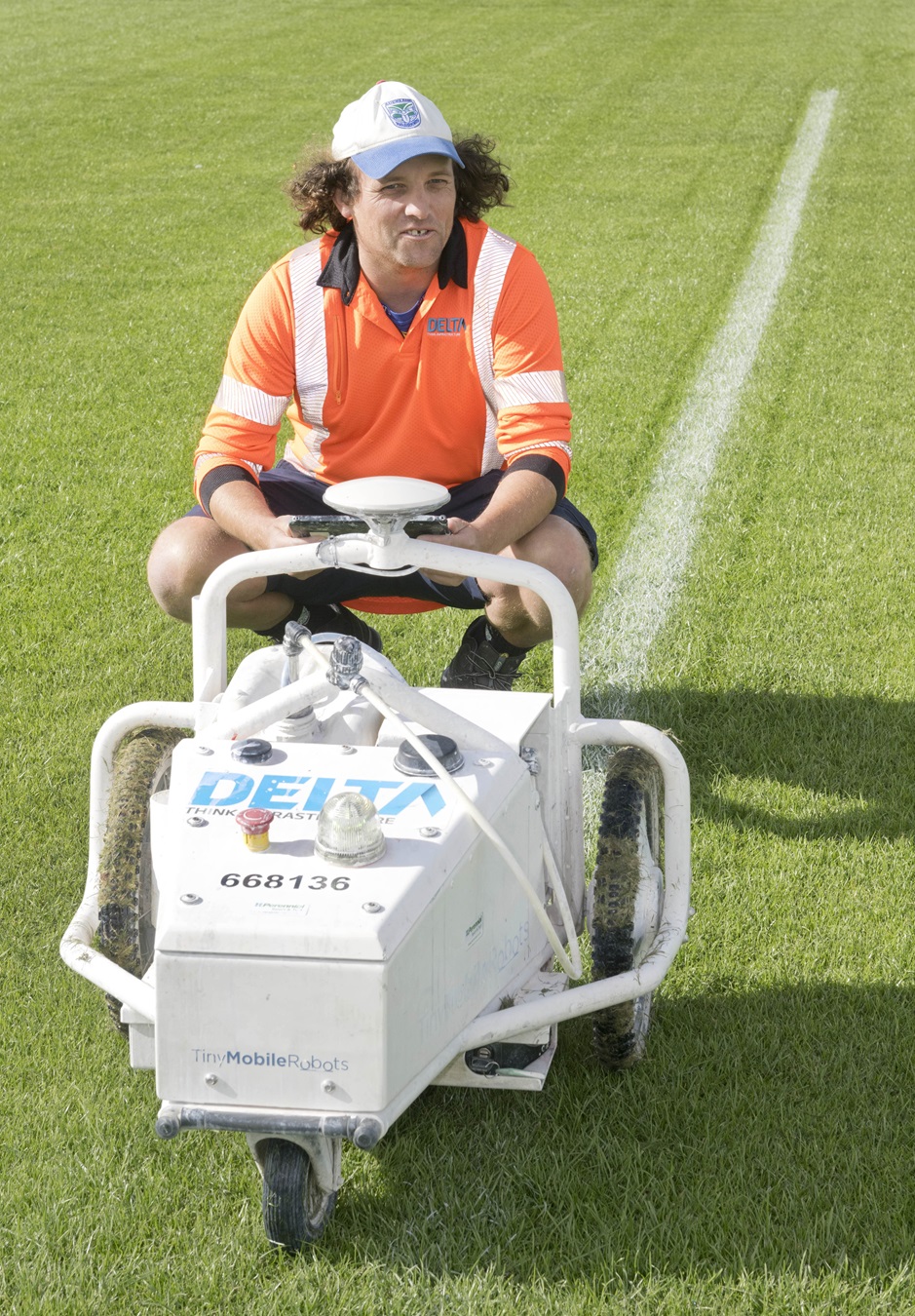 Steve, the GPS-controlled robotic line marker, and Delta contracts superviser Simon Smaill mark...
