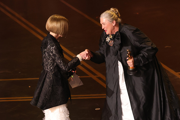 Dame Anna Wintour (left) presented the Academy Award to Kate Hawley for her work on Frankenstein....