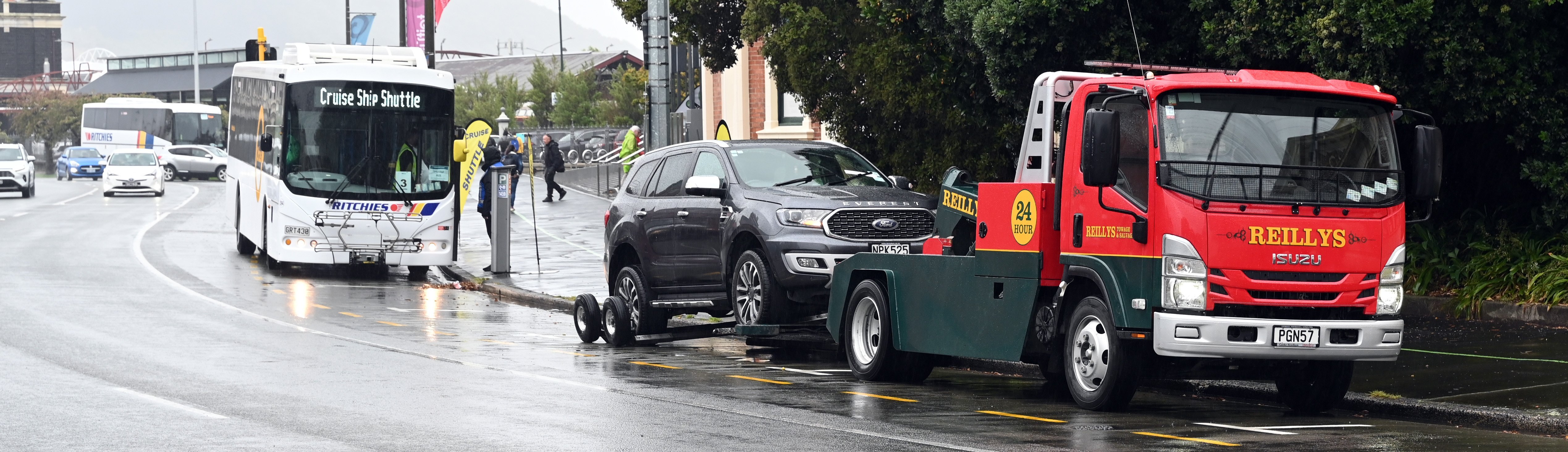 A car is towed last month to make way for cruise ship buses. Signs were supposed to be situated...