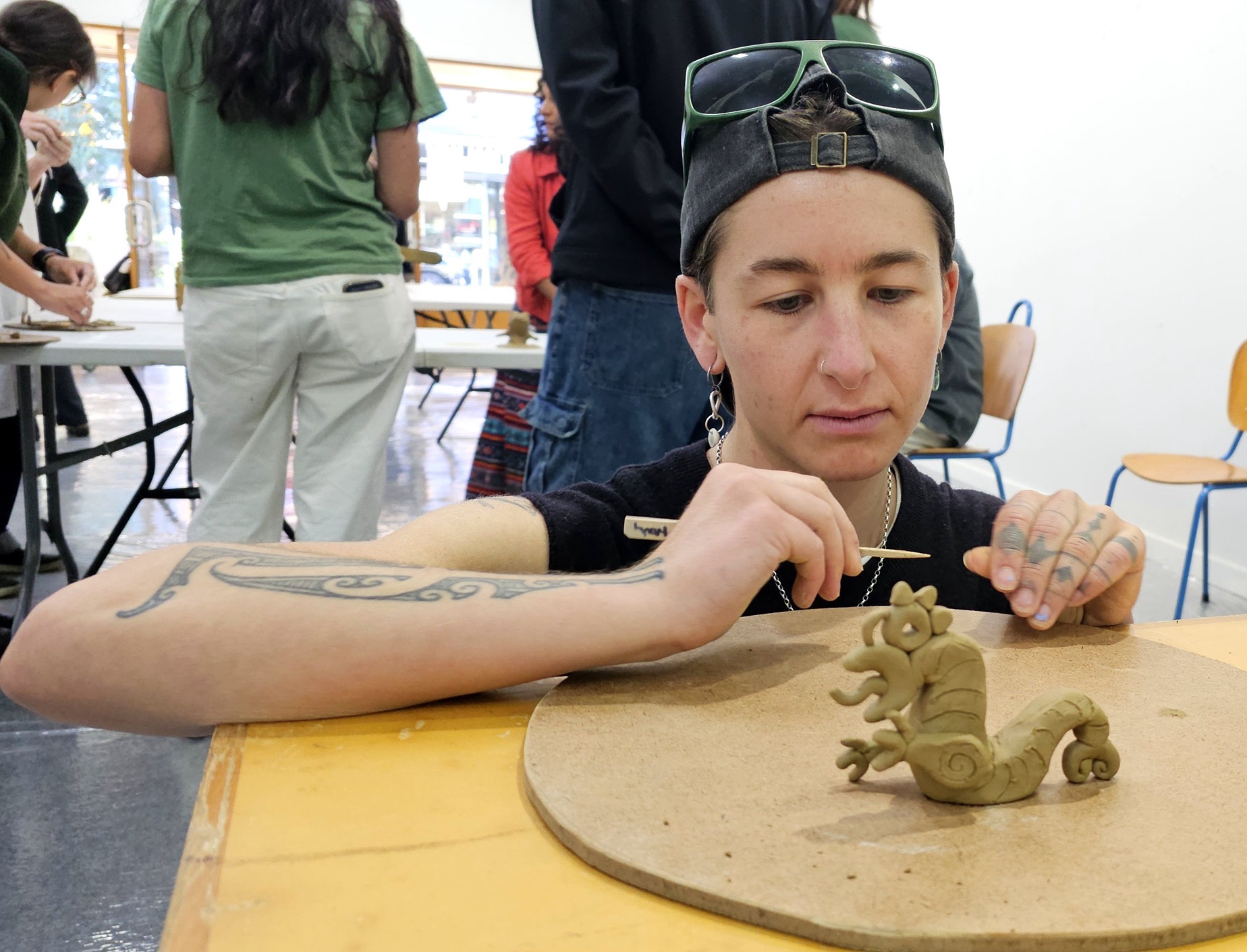 Jess Nicholson crafts a manaia, a Māori deity and spiritual protector.

