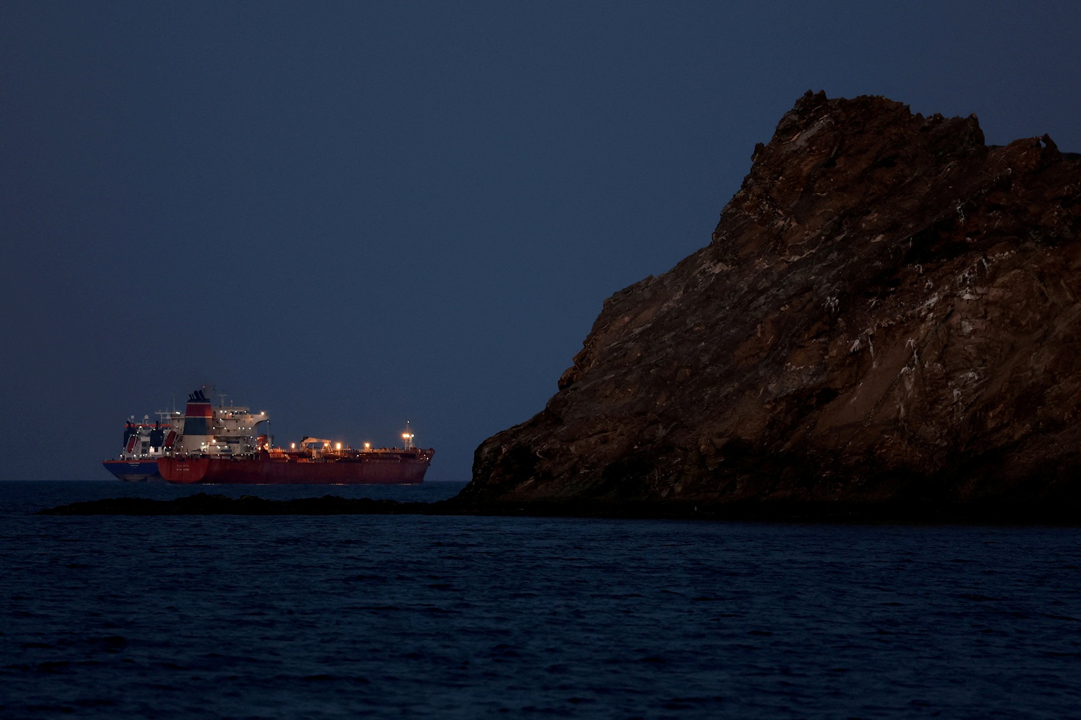 A tanker sits anchored near Muscat, Oman as traffic is stalled in the Strait of Hormuz. File...