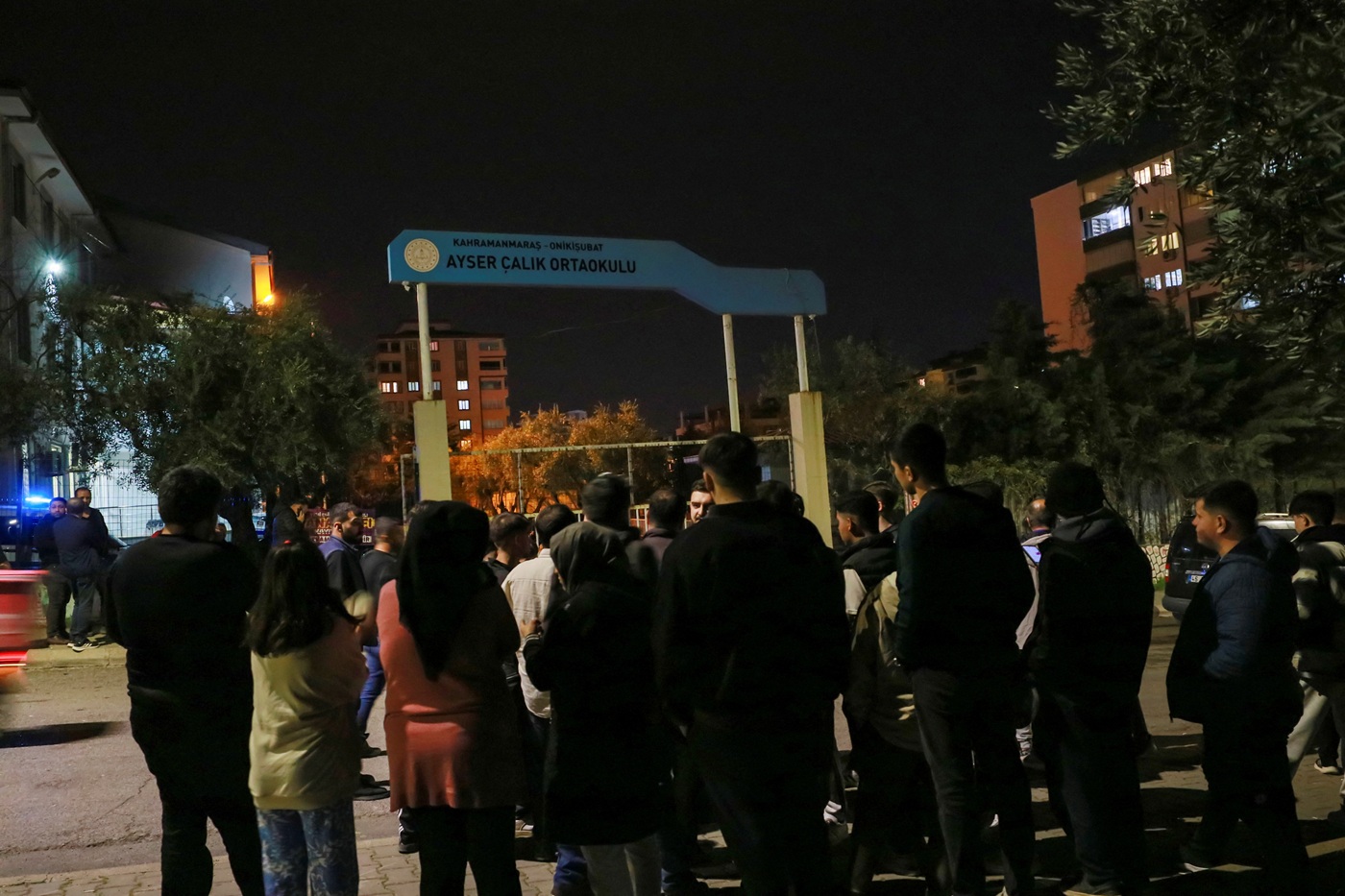 People gather in front of the school following the shooting in Turkey's southeastern province of...