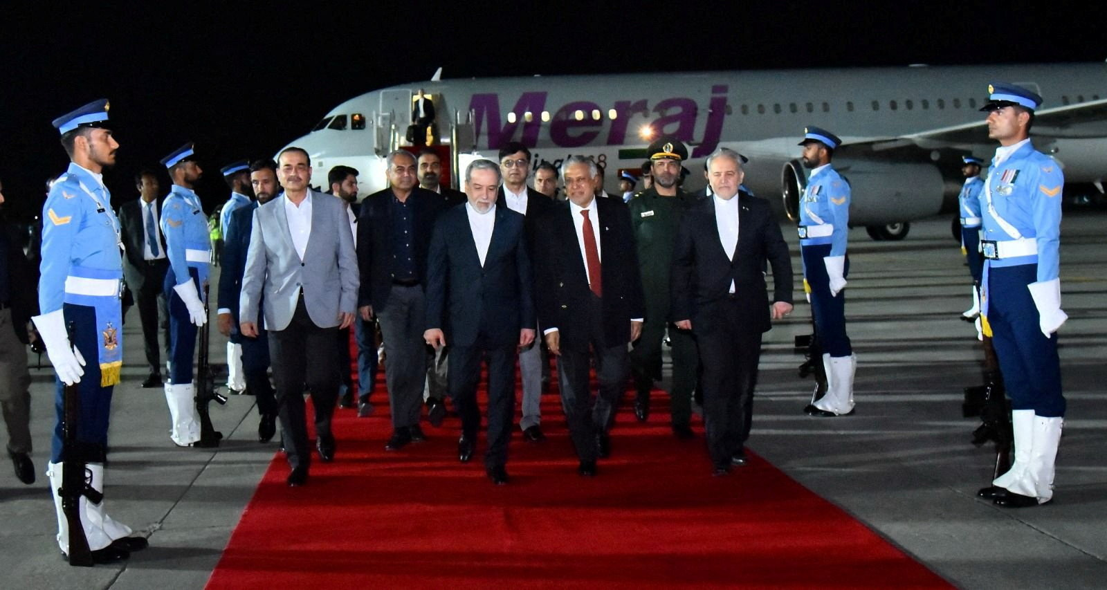 Iranian Foreign Minister Abbas Araqchi walks with Pakistan's Foreign Minister Mohammad Ishaq Dar...