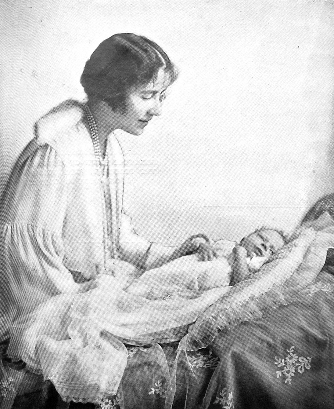 Elizabeth, Duchess of York (later Queen and future Queen Mother) with her baby, the future Queen...