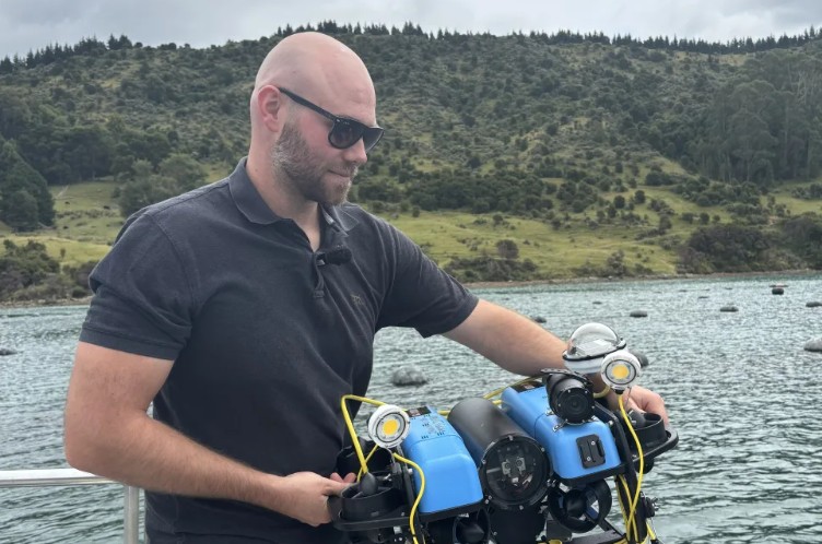 UWAI Robotics co founder Tim Rensen deploying the underwater drone to scan mussel lines on a farm...