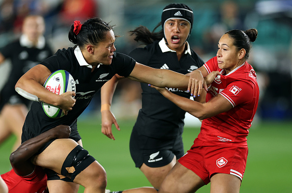 Black Fern Kaipo Olsen-Baker fends off a tackle from Canada's Shoshanah Seumanutafa in Kansas...